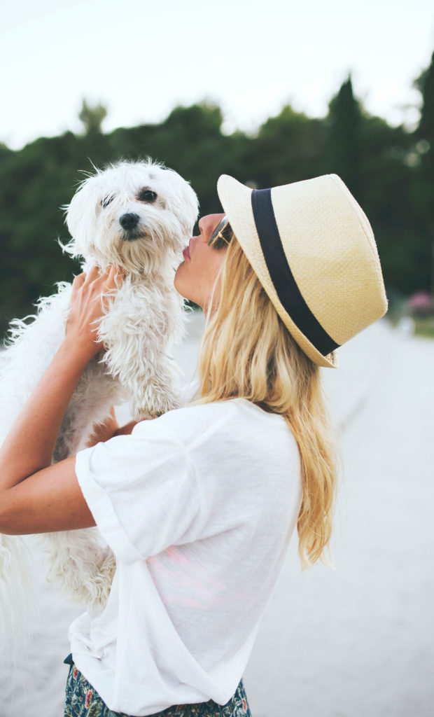 Woman kissing her dog