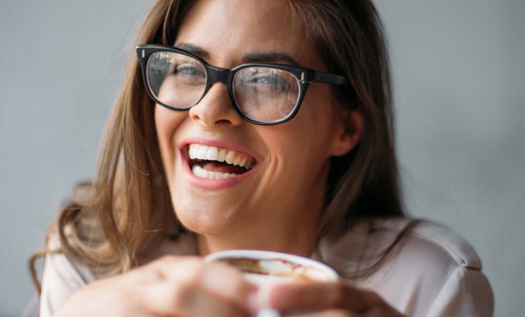 Woman smiling with coffee cup