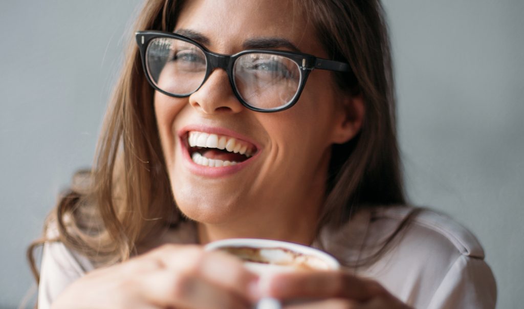 Woman smiling with coffee cup