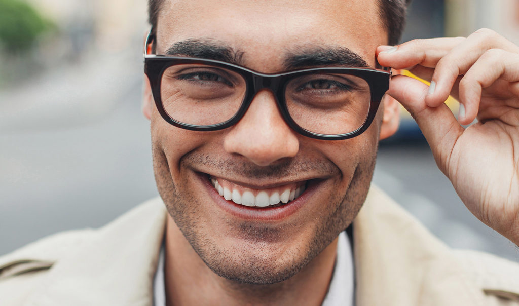 Man with glasses smiling