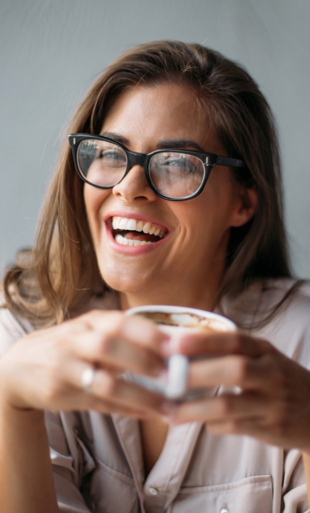 Woman smiling with coffee cup